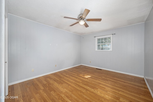 3701 College View Dr, Joplin, MO 64801 - spare room featuring wood finished floors, a ceiling fan, and a textured ceiling
