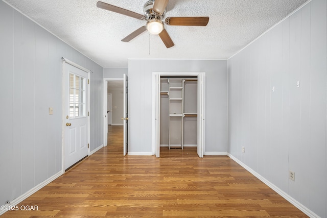3701 College View Dr, Joplin, MO 64801 - unfurnished bedroom featuring light wood-style flooring, a textured ceiling, and ceiling fan