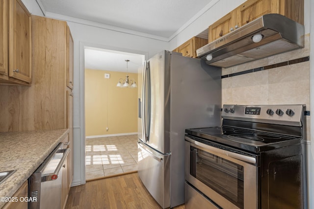 3701 College View Dr, Joplin, MO 64801 - kitchen featuring stainless steel appliances, under cabinet range hood, a chandelier, light wood-type flooring, and light countertops