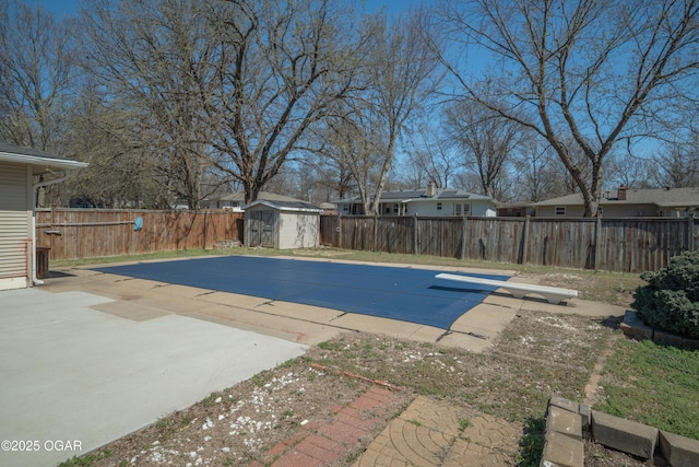3701 College View Dr, Joplin, MO 64801 - view of swimming pool featuring a storage unit, a fenced backyard, a diving board, and a patio