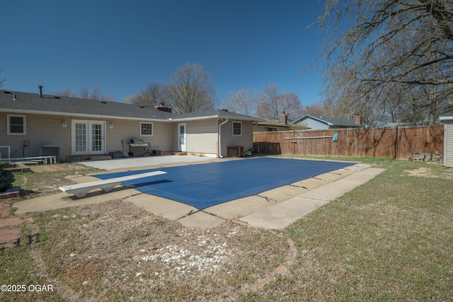 3701 College View Dr, Joplin, MO 64801 - view of swimming pool with french doors, a diving board, a patio, and grilling area
