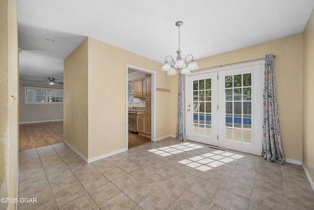 3701 College View Dr, Joplin, MO 64801 - unfurnished dining area with a chandelier, french doors, ceiling fan, and light tile patterned floors