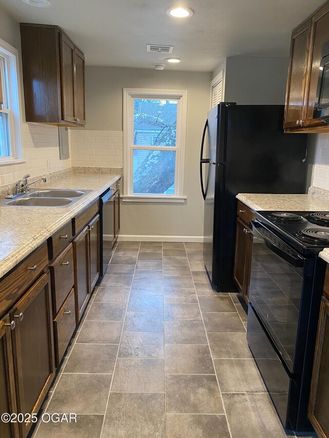 801 S Picher Ave, Joplin, MO 64801 - kitchen featuring electric range, tasteful backsplash, dark brown cabinets, light countertops, and dishwasher