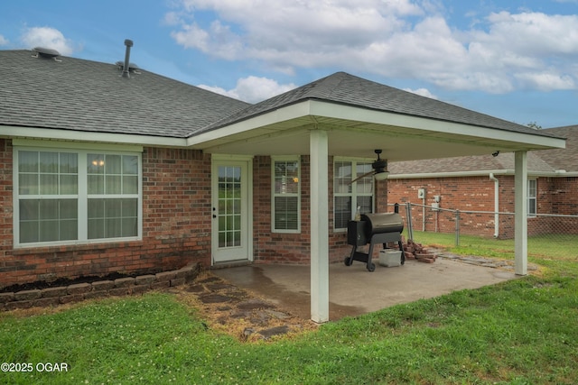 2238 Holly Ln, Miami, OK 74354 - back of house featuring a patio, brick siding, and roof with shingles