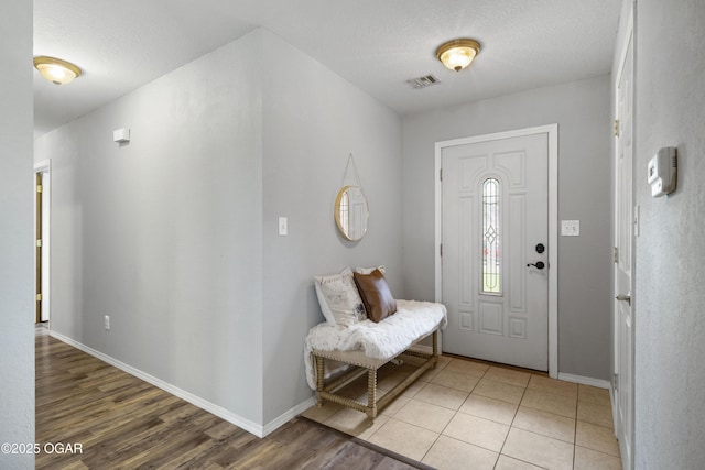 2238 Holly Ln, Miami, OK 74354 - entryway with light wood-type flooring and a textured ceiling