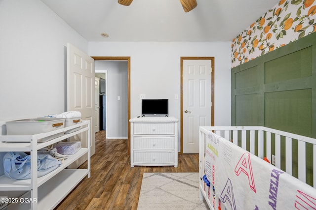 2238 Holly Ln, Miami, OK 74354 - bedroom featuring dark wood finished floors, a crib, and a ceiling fan