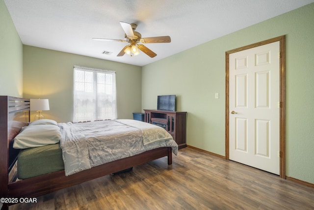2238 Holly Ln, Miami, OK 74354 - bedroom featuring wood finished floors and ceiling fan