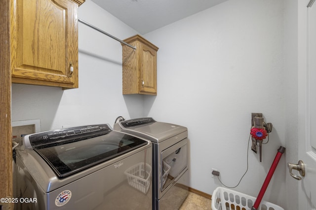 2238 Holly Ln, Miami, OK 74354 - laundry room featuring cabinet space, washing machine and dryer, and light tile patterned flooring