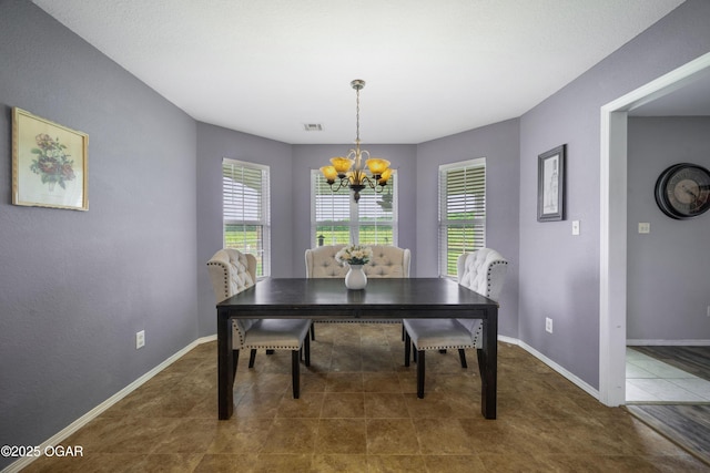 2238 Holly Ln, Miami, OK 74354 - tiled dining space featuring a chandelier and baseboards