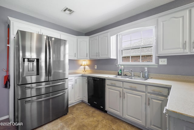 2238 Holly Ln, Miami, OK 74354 - kitchen with stainless steel refrigerator with ice dispenser, dishwasher, light countertops, and white cabinetry