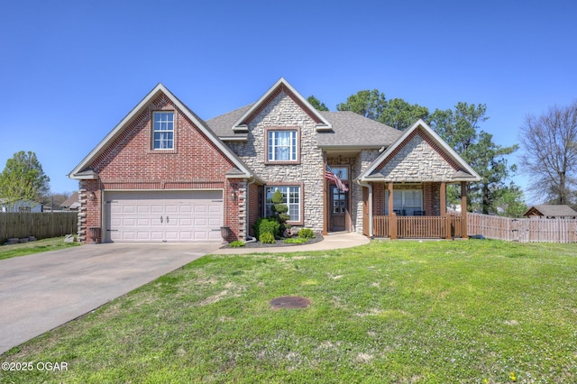 917 Monroe Cir, Carl Junction, MO 64834 - view of front of property featuring stone siding, concrete driveway, a garage, and brick siding