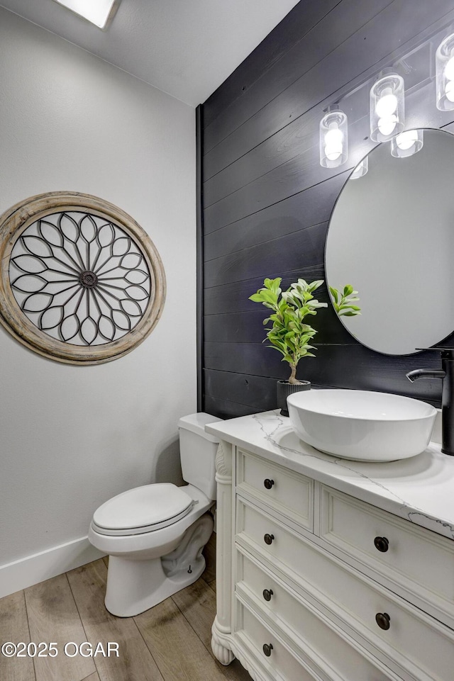 917 Monroe Cir, Carl Junction, MO 64834 - half bathroom featuring vanity, wood finished floors, and wood walls