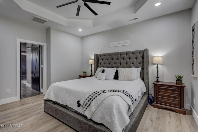 917 Monroe Cir, Carl Junction, MO 64834 - bedroom featuring a raised ceiling, light wood finished floors, recessed lighting, a ceiling fan, and ensuite bath