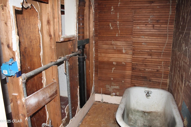 2414 W 4th St, Joplin, MO 64801 - bathroom featuring a freestanding tub and wooden walls