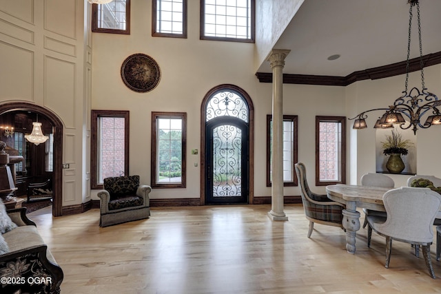 1126 Carrington Ter, Joplin, MO 64804 - entryway featuring a chandelier, a high ceiling, plenty of natural light, ornate columns, and light wood-type flooring