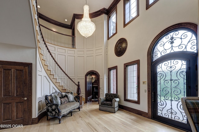 1126 Carrington Ter, Joplin, MO 64804 - foyer entrance with a high ceiling, stairs, a chandelier, plenty of natural light, and arched walkways