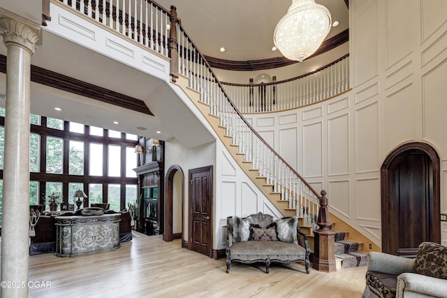 1126 Carrington Ter, Joplin, MO 64804 - foyer entrance with a high ceiling, a decorative wall, stairs, a chandelier, and decorative columns