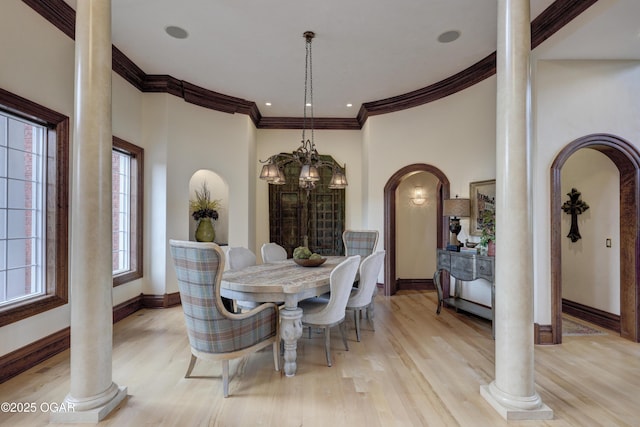 1126 Carrington Ter, Joplin, MO 64804 - dining room featuring decorative columns, arched walkways, crown molding, and a chandelier