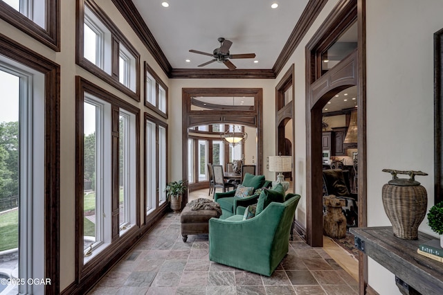 1126 Carrington Ter, Joplin, MO 64804 - sunroom / solarium featuring plenty of natural light, recessed lighting, ornamental molding, arched walkways, and stone finish flooring