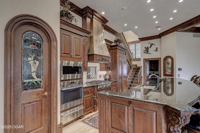 1126 Carrington Ter, Joplin, MO 64804 - kitchen featuring appliances with stainless steel finishes, a warming drawer, crown molding, recessed lighting, and a spacious island