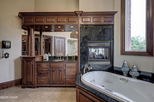1126 Carrington Ter, Joplin, MO 64804 - full bath featuring a tub with jets, vanity, tile patterned flooring, and a tiled fireplace