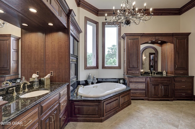 1126 Carrington Ter, Joplin, MO 64804 - full bath with two vanities, a garden tub, ornamental molding, and a chandelier