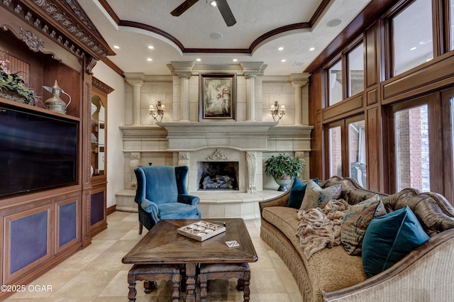 1126 Carrington Ter, Joplin, MO 64804 - living area featuring ornamental molding, ceiling fan, ornate columns, a premium fireplace, and recessed lighting
