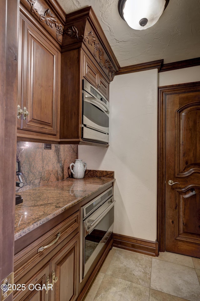 1126 Carrington Ter, Joplin, MO 64804 - kitchen with oven, stone countertops, and tasteful backsplash