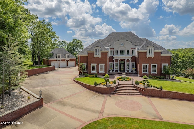 1126 Carrington Ter, Joplin, MO 64804 - french country style house featuring an outdoor structure, a front yard, brick siding, and concrete driveway