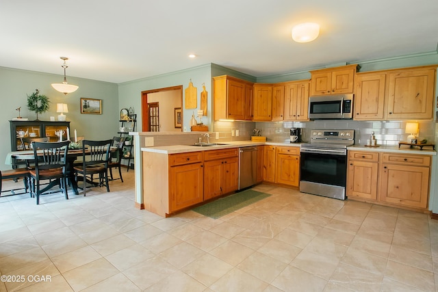 2005 Laura Ln, Joplin, MO 64801 - kitchen featuring stainless steel appliances, light countertops, backsplash, a peninsula, and hanging light fixtures
