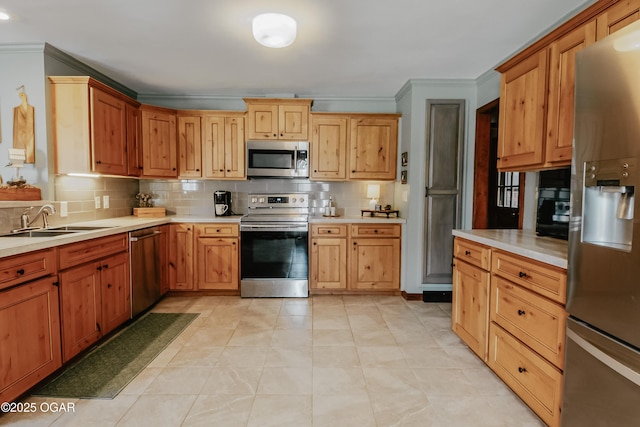2005 Laura Ln, Joplin, MO 64801 - kitchen featuring appliances with stainless steel finishes, crown molding, backsplash, light countertops, and light tile patterned floors