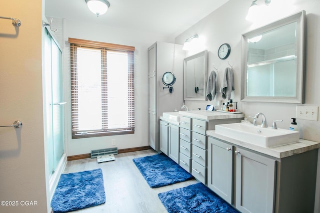 2005 Laura Ln, Joplin, MO 64801 - full bath featuring double vanity, wood finished floors, and a shower with shower door