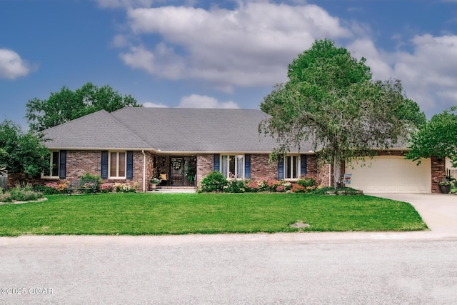 2005 Laura Ln, Joplin, MO 64801 - view of front of property featuring concrete driveway, an attached garage, a front yard, and brick siding
