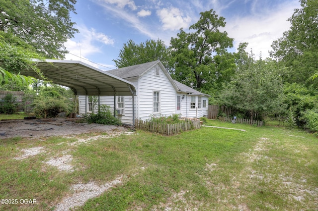 1123 Garden Grove Rd, Joplin, MO 64801 - view of home's exterior featuring a carport, a shingled roof, and driveway
