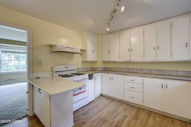 1123 Garden Grove Rd, Joplin, MO 64801 - kitchen with under cabinet range hood, white gas range, light countertops, and white cabinets