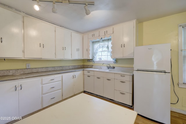 1123 Garden Grove Rd, Joplin, MO 64801 - kitchen with freestanding refrigerator, light countertops, and rail lighting