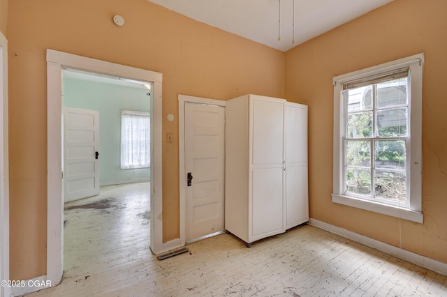 1123 Garden Grove Rd, Joplin, MO 64801 - unfurnished bedroom featuring multiple windows and light wood finished floors