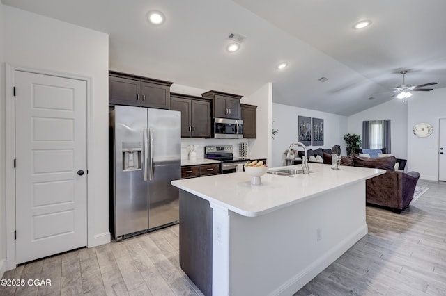 2008 Greydon Ln, Webb City, MO 64870 - kitchen featuring appliances with stainless steel finishes, light wood-style floors, dark brown cabinetry, vaulted ceiling, and a ceiling fan
