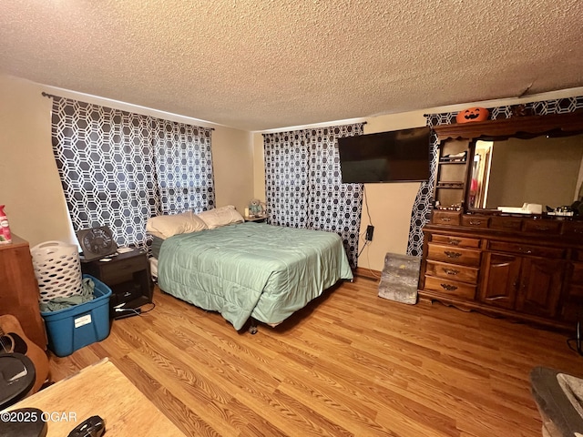 303 E Centennial Ave, Carthage, MO 64836 - bedroom featuring a textured ceiling and wood finished floors
