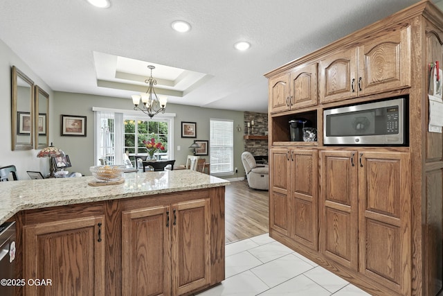 302 E 44th St, Joplin, MO 64804 - kitchen featuring appliances with stainless steel finishes, a chandelier, light stone countertops, a tray ceiling, and recessed lighting