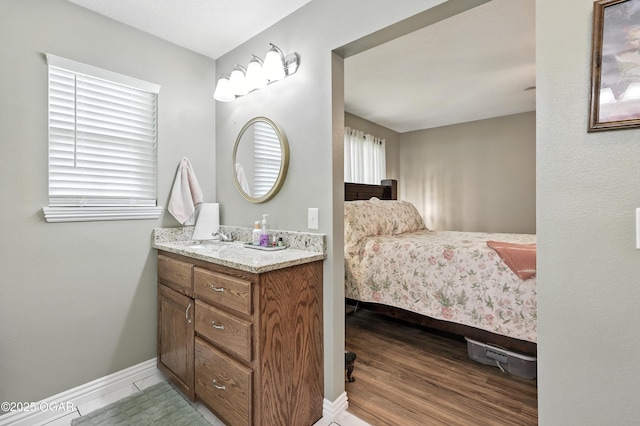 302 E 44th St, Joplin, MO 64804 - bathroom with vanity and wood finished floors