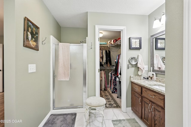 302 E 44th St, Joplin, MO 64804 - bathroom featuring vanity, a shower stall, and a walk in closet