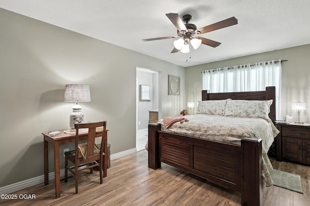 302 E 44th St, Joplin, MO 64804 - bedroom featuring multiple windows, light wood-style floors, and a ceiling fan