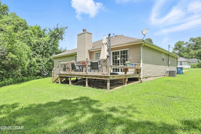 302 E 44th St, Joplin, MO 64804 - back of property featuring a lawn, a wooden deck, a chimney, and a shingled roof