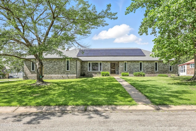 1901 Laura Ln, Joplin, MO 64801 - view of front of home with roof mounted solar panels, brick siding, a front lawn, and roof with shingles