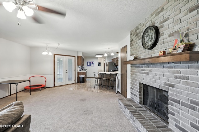1901 Laura Ln, Joplin, MO 64801 - living area with light colored carpet, a textured ceiling, a fireplace, ceiling fan, and french doors
