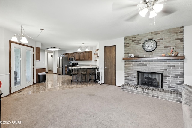 1901 Laura Ln, Joplin, MO 64801 - living area with a ceiling fan, a brick fireplace, and light colored carpet