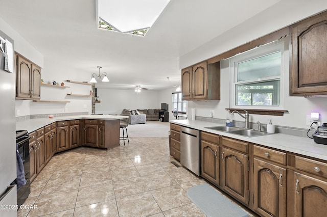 1901 Laura Ln, Joplin, MO 64801 - kitchen featuring stainless steel dishwasher, open floor plan, light countertops, and healthy amount of natural light