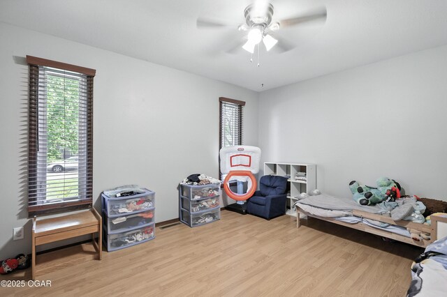 1901 Laura Ln, Joplin, MO 64801 - bedroom featuring wood finished floors, multiple windows, and a ceiling fan