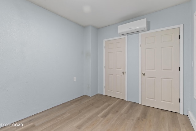 119 Jared Blvd, Webb City, MO 64870 - unfurnished bedroom featuring a wall mounted air conditioner and light wood finished floors